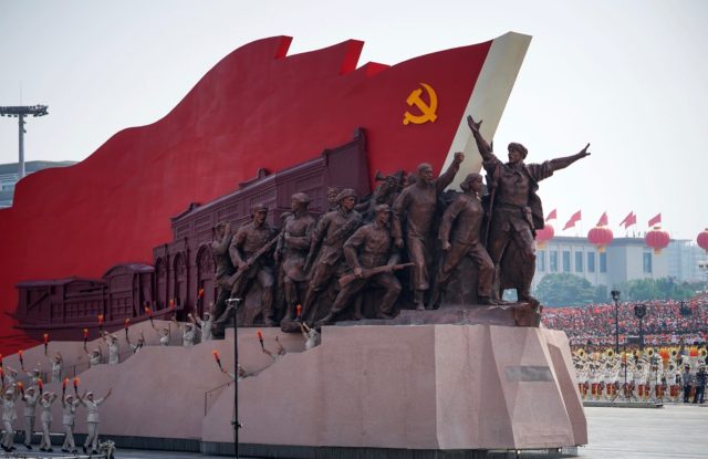 BEIJING, CHINA - OCTOBER 01: A float featuring the hammer and sickle is seen during a para