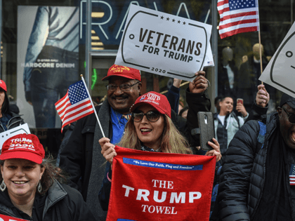 Trump supporters hold signs on the sidelines during the Veterans Day parade on November 11, 2019 in New York City. U.S. President Donald Trump, the first sitting U.S. president to attend New York's parade, offered a tribute to veterans ahead of the 100th annual parade which draws thousands of vets …