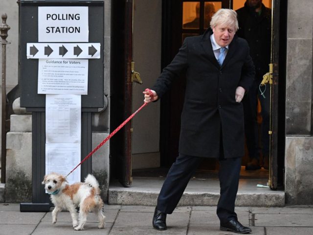 TOPSHOT - Britain's Prime Minister Boris Johnson and his dog Dilyn leave from a Polling Station, after he cast his ballot paper and voted, in central London on December 12, 2019, as Britain holds a general election. (Photo by DANIEL LEAL-OLIVAS / AFP) (Photo by DANIEL LEAL-OLIVAS/AFP via Getty Images)