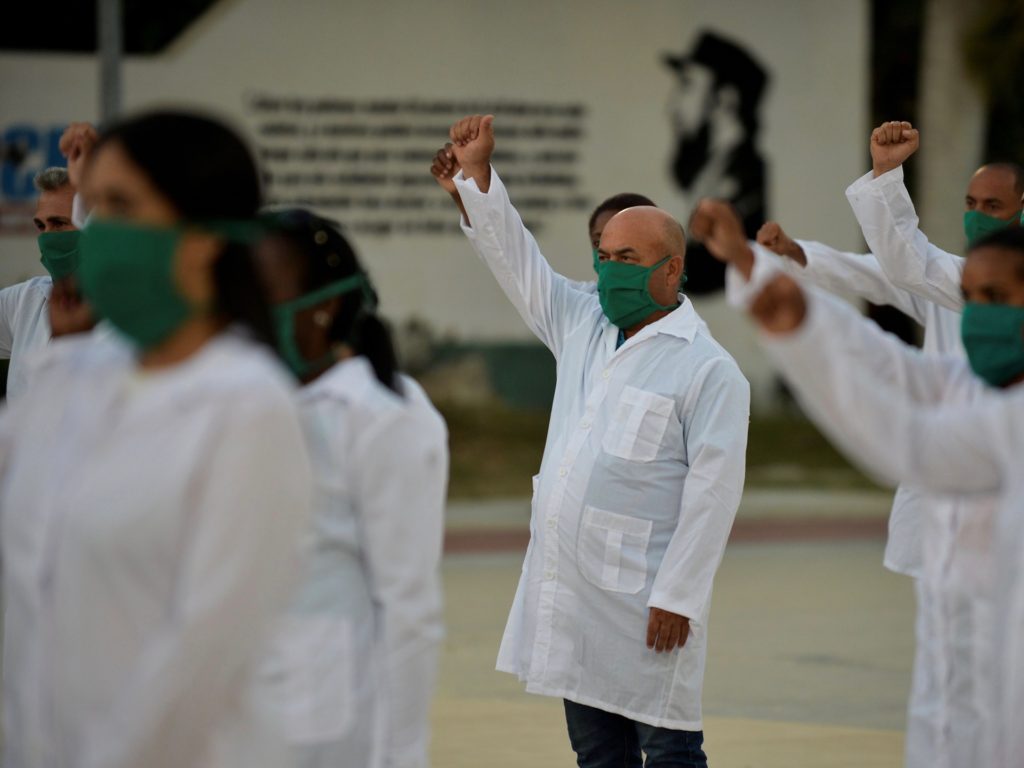 Doctors and nurses of Cuba's Henry Reeve International Medical Brigade take part in a farewell ceremony before traveling to Andorra to help in the fight against the coronavirus COVID-19 pandemic, at the Central Unit of Medical Cooperation in Havana, on March 28, 2020. (Photo by YAMIL LAGE / AFP) (Photo by YAMIL LAGE/AFP via Getty Images)