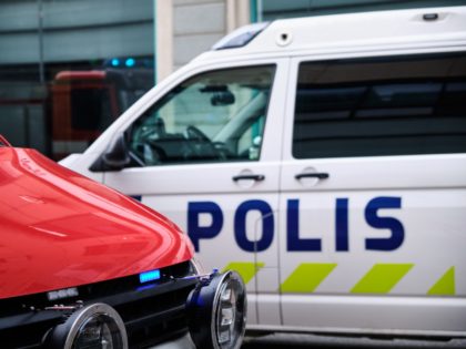 The fire car with a blue light and a police car on the street in Finland.