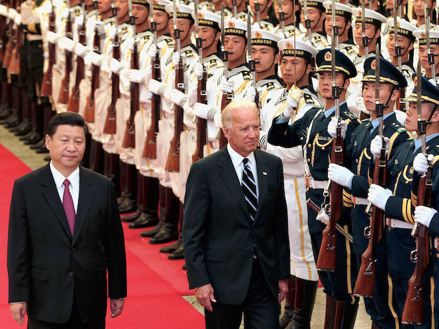 In this August 2011 file photo, then Vice President Xi Jinping accompanies then Vice President Joe Biden to view an honor guard during a welcoming ceremony. (Lintao Zhang/Getty Images)