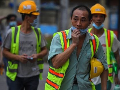 Chinese workers facemasks leave the construction a at the end of their in Colombo on March 25, 2020. (Photo by Ishara S. KODIKARA / AFP) (Photo by ISHARA S. KODIKARA/AFP via Getty Images)