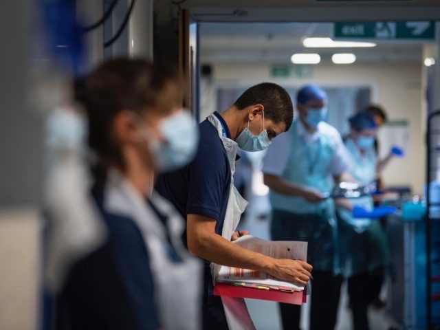 A Rehab Support worker checks on patient notes as the first patients are admitted to the the NHS Seacole Centre at Headley Court, Surrey on May 28, 2020, a disused military hospital, which has been converted during the novel coronavirus COVID-19 pandemic. - Named in honour of Jamaican born nurse, …