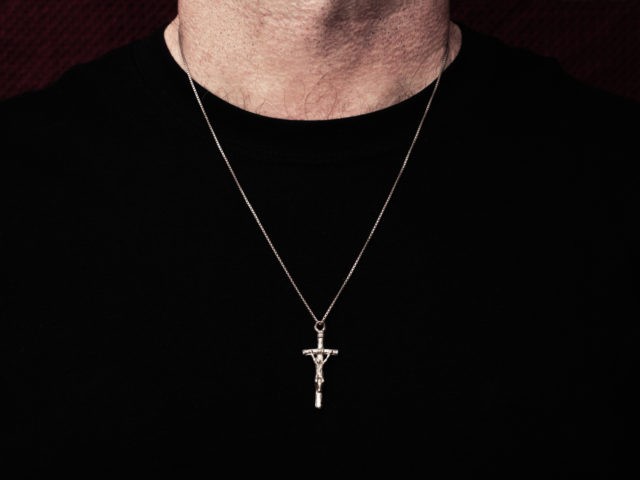 Man wearing silver crucifix pendant