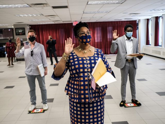 NEW YORK, NY - JULY 02: People are sworn in as new American citizens during a ceremony at the U.S. Citizenship and Immigration Services’ New York Field Office on July 2, 2020 in New York City. The ceremonies were brief and observed precautions, like wearing a mask and adhering to …