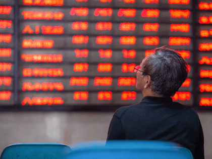 An investor looks at screens showing stock market movements at a securities company in Nanjing in China's eastern Jiangsu province on July 6, 2020. - Shanghai stocks surged on July 6 to a more than two-year high as investors piled in following a combination of rosy predictions for the market …