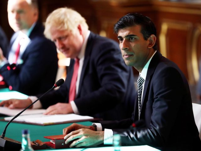 LONDON, ENGLAND - JULY 21: Prime Minister Boris Johnson sits beside Chancellor of the Exchequer Rishi Sunak during a face-to-face meeting of his cabinet team of ministers, the first since mid-March, at the Foreign and Commonwealth Office (FCO) on July 21, 2020 in London, England. The meeting in the FCO …