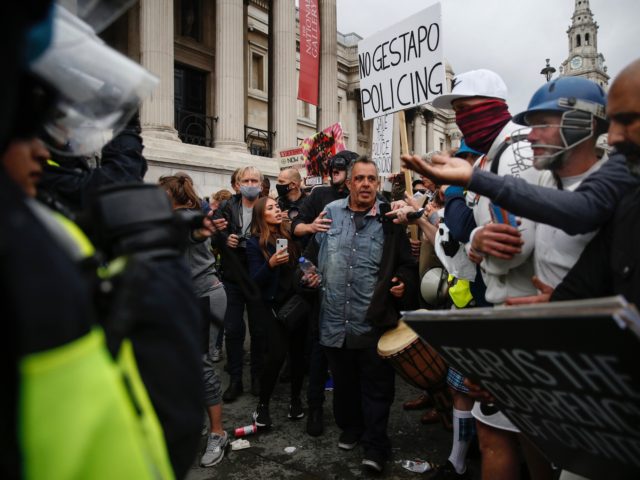 LONDON, ENGLAND - SEPTEMBER 26: Protesters clash with police officers during a "We Do Not Consent" anti-lockdown rally at Trafalgar Square on September 26, 2020 in London, England. Thousands of anti-mask demonstrators protested in Trafalgar Square after the British government imposed tighter coronavirus laws this week. (Photo by Hollie Adams/Getty …