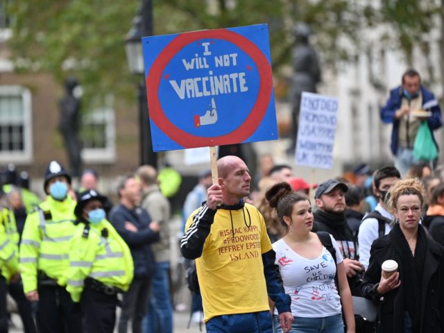 A demonstrator carries an anti-vaccination sign at a protest action against restrictions imposed during the novel coronavirus COVID-19 pandemic, outside Downing Street, central London on October 10, 2020. - British Prime Minister Boris Johnson is expected next week to outline a new three-tier lockdown system as rates of coronavirus infection …