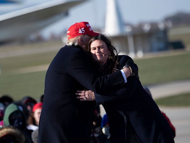 US President Donald Trump hugs his former press secretary Sarah Huckabee Sanders during a Make America Great Again rally at Dubuque Regional Airport on November 1, 2020, in Dubuque, Iowa. - Donald Trump vowed to again defy the polls as he sprinted through five swing states in a blitz of …