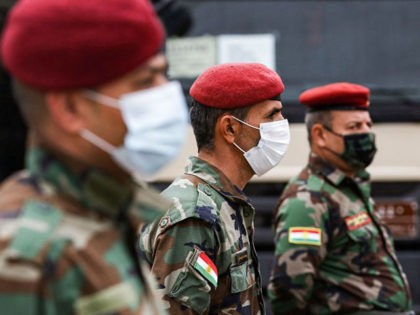Members of the Iraqi-Kurdish Peshmerga forces attend a handover and US military and logistic assistance distribution ceremony to the Peshmerga Ministry of the Kurdistan Regional Government (KRG) in the Arbil the capital of the autonomous Kurdish region in northern Iraq on November 10, 2020. (Photo by SAFIN HAMED / AFP) …