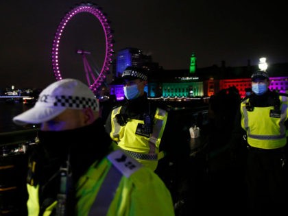 LONDON, ENGLAND - DECEMBER 31: Met Police officers attempt to disperse crowds gathered on
