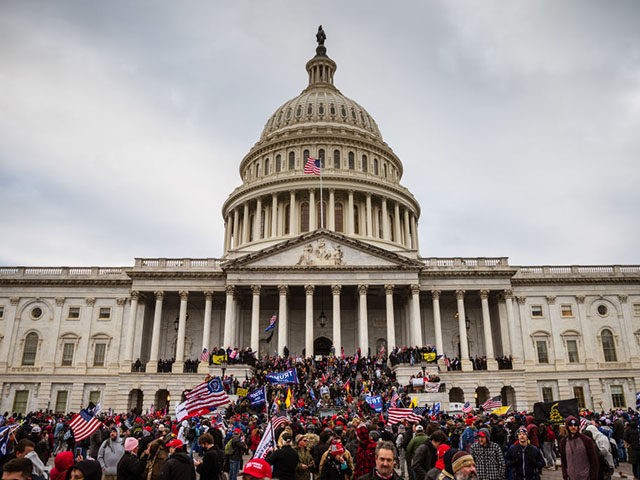 WASHINGTON, DC - JANUARY 06: A large group of pro-Trump protesters stand on the East steps of the Capitol Building after storming its grounds on January 6, 2021 in Washington, DC. A pro-Trump mob stormed the Capitol, breaking windows and clashing with police officers. Trump supporters gathered in the nation's …