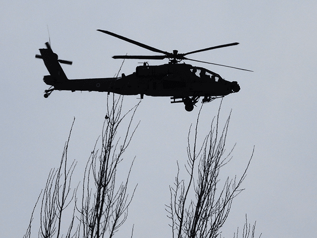 An Indian Air Force (IAF) Apache helicopter flies over Leh, the joint capital of the union