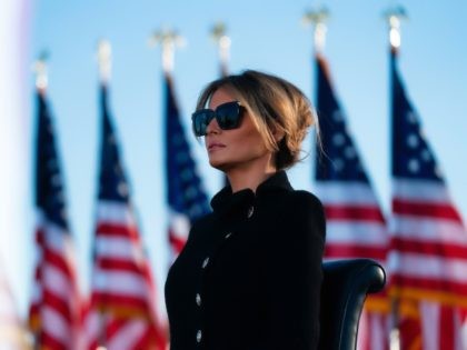 Melania Trump listens as her husband Outgoing US President Donald Trump addresses guests at Joint Base Andrews in Maryland on January 20, 2021. - President Trump and the First Lady travel to their Mar-a-Lago golf club residence in Palm Beach, Florida, and will not attend the inauguration for President-elect Joe …
