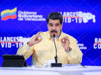 Handout picture released by the Venezuelan Presidency showing Venezuela's President Nicolas Maduro (C) speaking while showing a vial of Carvativir, during a televised message at Miraflores Presidential Palace in Caracas on January 24, 2021. - Carvativir is the latest in a series of remedies, without published medical studies allowing independent …