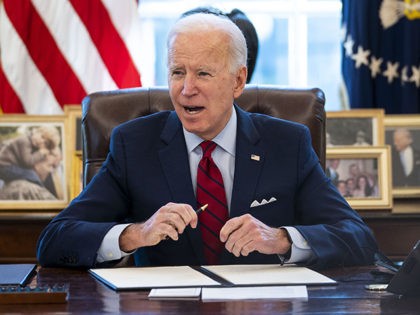 WASHINGTON, DC - JANUARY 28: U.S. President Joe Biden signs executive actions in the Oval Office of the White House on January 28, 2021 in Washington, DC. President Biden signed a series of executive actions Thursday afternoon aimed at expanding access to health care, including re-opening enrollment for health care …