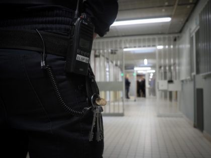 An officer of penitentiary administration stands in a corridor of the Saint-Maur prison on