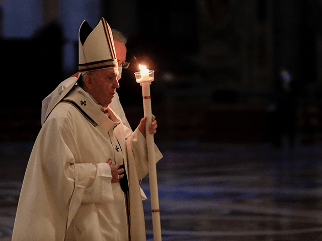 Pope Francis holds a candle as he arrives to celebrate Mass on the occasion of the celebration of the World Day of Consecrated Life at St. Peter's Basilica in the Vatican on February 2, 2021. (Photo by Andrew Medichini / POOL / AFP) (Photo by ANDREW MEDICHINI/POOL/AFP via Getty Images)