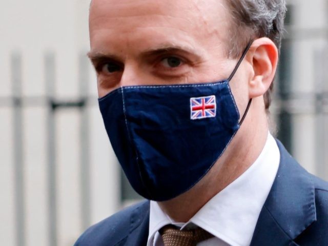 Britain's Foreign Secretary Dominic Raab wearing a face mask bearing a Union Flag mot