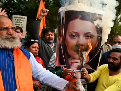 Activists of United Hindu Front (UHF) burn an effigy with a picture of Swedish climate activist Greta Thunberg during a demonstration in New Delhi on February 4, 2021, after she made comments on social media about ongoing mass farmers' protests in India. (Photo by Money SHARMA / AFP) (Photo by …