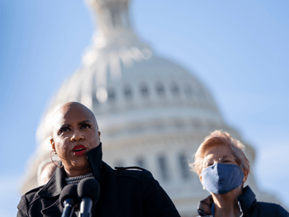 Rep. Ayanna Pressley (D-MA) speaks as Sen. Elizabeth Warren (D-MA) looks on during a press conference about student debt outside the U.S. Capitol on February 4, 2021 in Washington, DC. The group of Democrats re-introduced their resolution calling on President Joe Biden to take executive action to cancel up to …