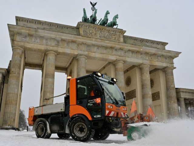 Snow is cleared in front of the Brandenburg Gate after fresh snowfall on February 8, 2021 in Berlin. (Photo by John MACDOUGALL / AFP) (Photo by JOHN MACDOUGALL/AFP via Getty Images)