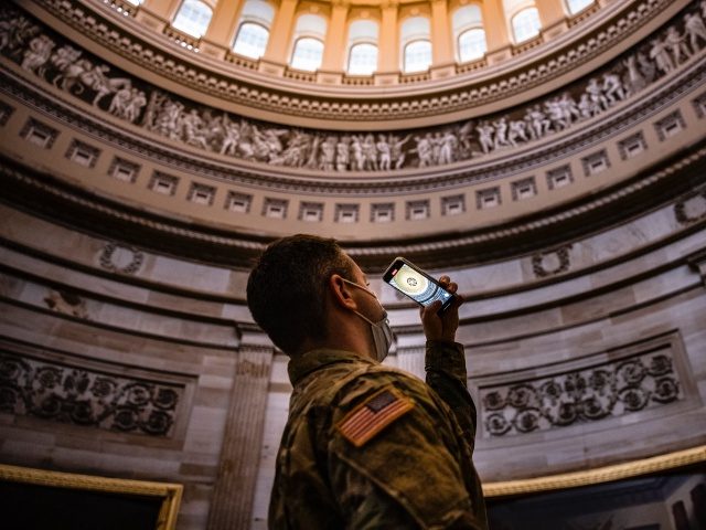 WASHINGTON, DC - FEBRUARY 11: A New York National Guard soldier takes a photo of the Rotunda during a tour of the US Capitol on February 11, 2021 in Washington, DC. National Guard troops from around the country continue to guard Capitol Hill as House impeachment managers continue to make …