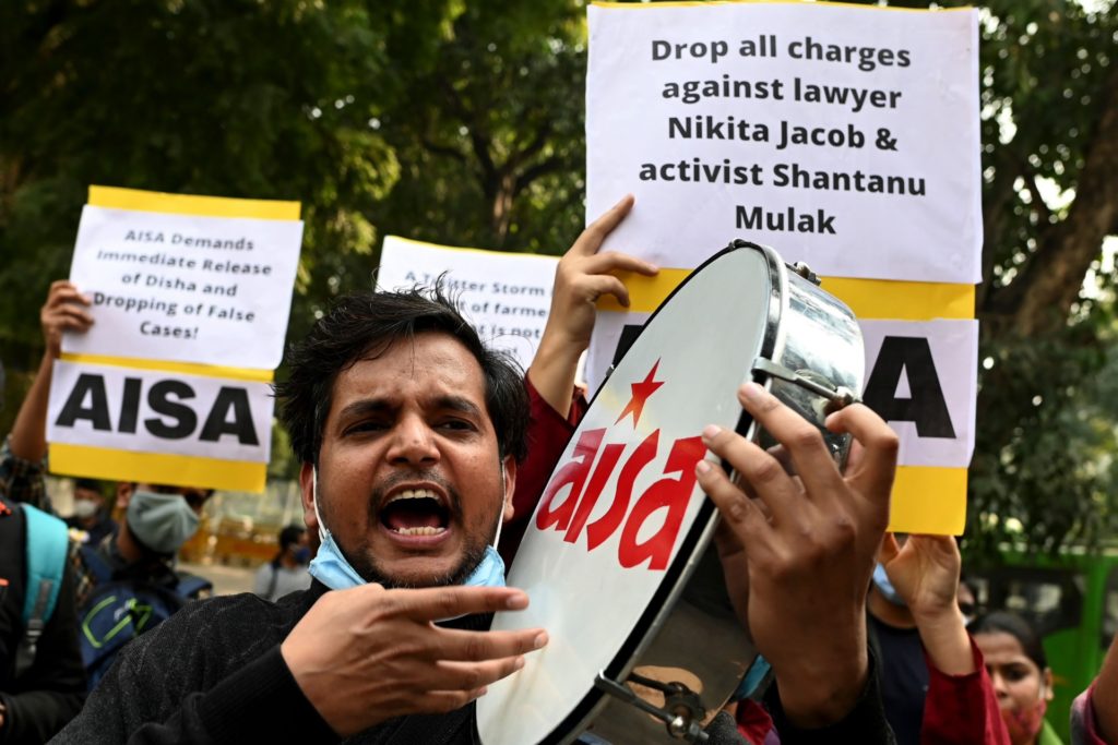 Demonstrators shout slogans during a protest against the arrest of climate change activist Disha Ravi by Delhi police for allegedly helping to create a guide for anti-government farmers protests shared by environmentalist Greta Thunberg, outside the Delhi Police headquarters, in New Delhi on February 16, 2021. (SAJJAD HUSSAIN/AFP via Getty Images)