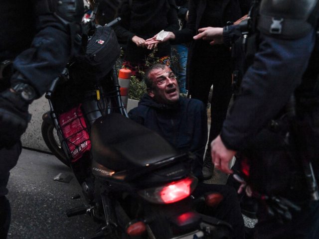 Motorised police officers detain a protester during a demonstration in Athens on February 24, 2021, in support to a jailed far left group member on hunger strike since 48 days. - Dimitris Koufodinas, 62, has been in intensive care since last week following his campaign to push for his transfer …
