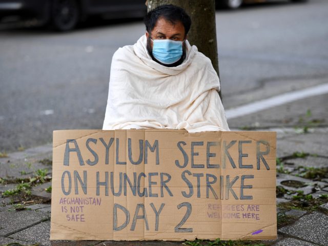 GLASGOW, SCOTLAND - SEPTEMBER 23: Abdul Safi, an Afghan asylum seeker, is joined by fellow Afghani’s as he hunger strikes outside the Home Office building on September 23, 2020 in Glasgow, Scotland. Mr Safi has stitched his lips together and gone on hunger strike in a last-ditch attempt to get …