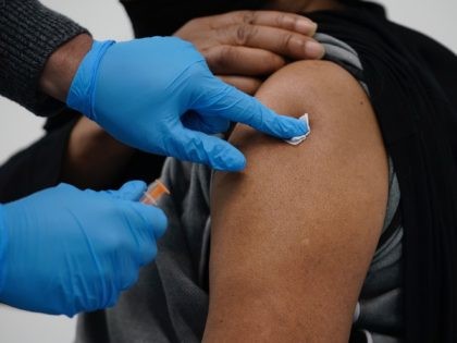WOLVERHAMPTON, ENGLAND - FEBRUARY 01: Delroy (surname witheld), aged 66, receives a coronavirus, Covid-19, vaccine at the Aldersley Leisure Village, one of the latest mass vaccination centres set up across the country on February 01, 2021 in Wolverhampton, England. More than 9 million people in the United Kingdom have received …