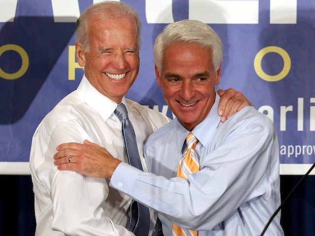 In this 2014 file photo, then Vice President Joe Biden stands with former Florida Governor Charlie Crist during a campaign event. (Joe Raedle/Getty Images)