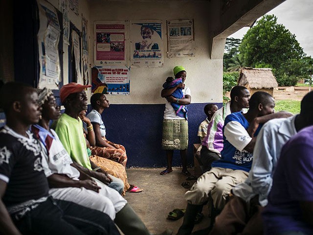 A mother holds her newborn in the remote health center in the Liberian village of Mendicor