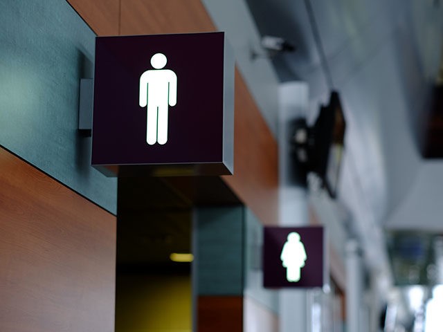 entrance to the male and female toilet. Sign in airport.