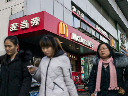 People walk past a McDonald's fast food restaurant in Beijing on January 9, 2017.