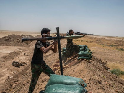 NINEVEH, IRAQ - JUNE 20: Iraqi PMF fighters on June 20, 2017 on the Iraq-Syria border in Nineveh, Iraq. The Popular Mobilisation Front (PMF) forces, composed of majority Shi'ite militia, part of the Iraqi forces, have pushed Islamic State militants from the north-western Iraq border strip back into Syria. The …