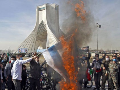Iranians burn an Israeli flag as they take part in a ceremony marking the 42nd anniversary of the 1979 Islamic Revolution, at the Azadi (Freedom) square in Tehran, on February 10, 2021. (Photo by STR / AFP) (Photo by STR/AFP via Getty Images)