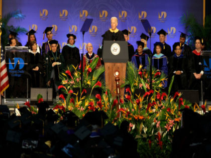 Vice President Joe Biden, center, speaks during a graduation ceremony at the Miami Dade College in Miami, Saturday, May 3,2014. Biden said a "constant, substantial stream of immigrants" is important to the American economy, urging citizenship for immigrants living in the U.S. illegally. (AP Photo/Javier Galeano)