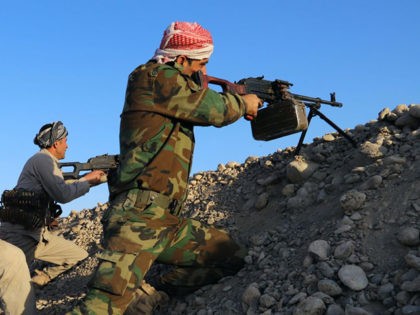Peshmerga fighters take aim from their position at the Altun Kubri checkpoint, 40kms from