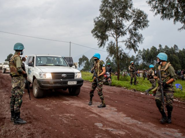 KIBUMBA, DEMOCRATIC REPUBLIC OF THE CONGO - FEBRUARY 22: UN peacekeepers and Congolese armed forces stand near an ambulance transporting a victim from the site where Italian Ambassador Luca Attanasio was fatally attacked when the convoy he was traveling in came under attack on February 22, 2021 near the village …