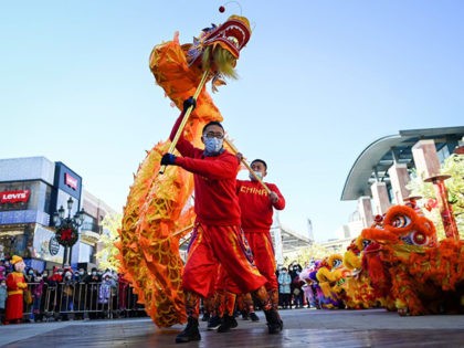 A dragon dance team perform outside a mall in Beijing on February 16, 2021, on the fifth day of the Lunar New Year, which ushered in the Year of the Ox on February 12. (Photo by WANG Zhao / AFP) (Photo by WANG ZHAO/AFP via Getty Images)