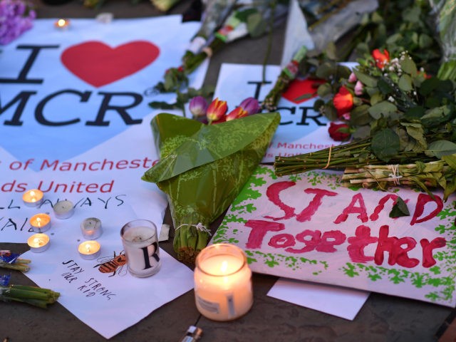TOPSHOT - Messages and floral tributes are seen in Albert Square in Manchester, northwest