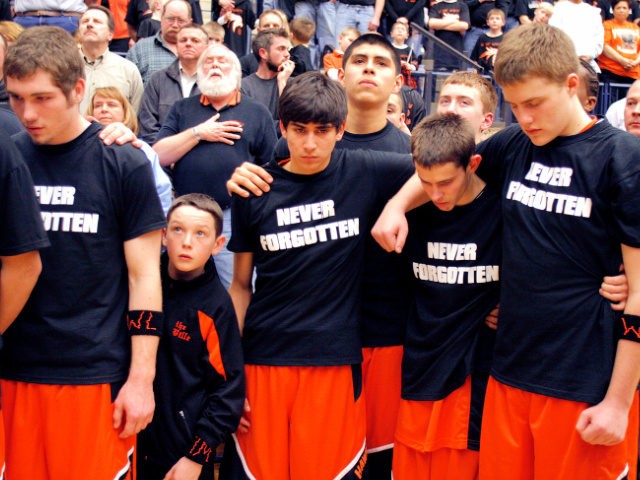 HOLLAND- March 7: Fennville High School basketball team members stand together for a momen