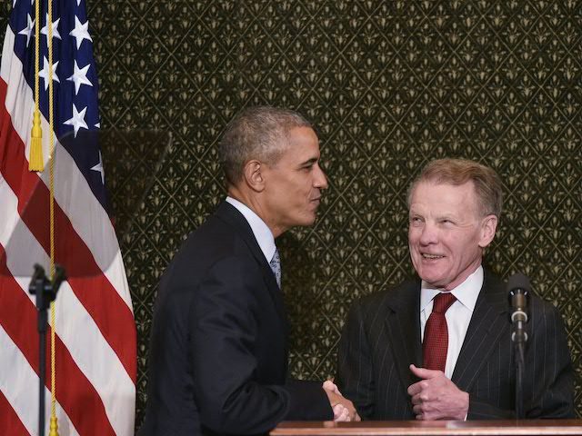 In this file photo, US President Barack Obama shakes hands with Illinois House Speaker Mic