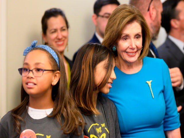 Speaker of the House Nancy Pelosi (R), D-CA, stands with Butterfly Effect founders Kaia Marbin (L), 11, and Lillian Ellis (C), 10, during a Congressional Tri-Caucus and the Butterfly Effect event to mark Universal Day of the Child and call for support of immigrant children who "have been or are …