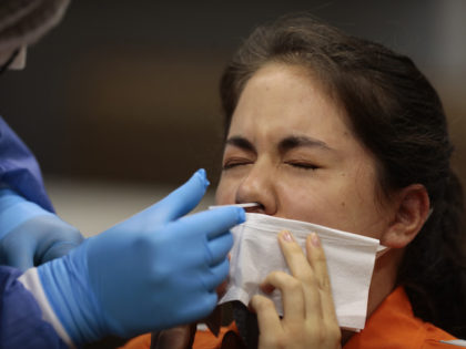 A health worker takes a nose swab test for COVID-19 in Ecuador. Flu tests are also administered with a nasal swab. Flu is at record lows this year. (Photo by Franklin Jacome/Agencia Press South/Getty Images)