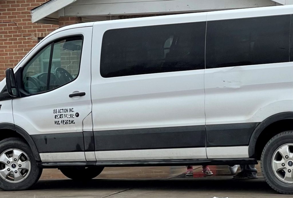 A U.S. Border Patrol contract transportation van drops off migrant families on February 14 at a shelter in Eagle Pass Texas. (Photo: Breitbart Texas/Randy Clark)