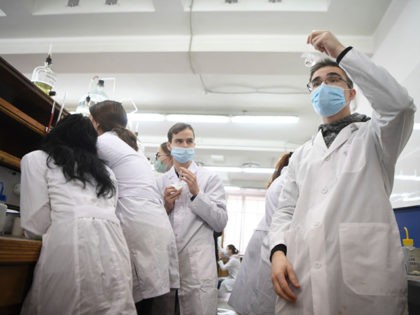Students wearing face masks conduct experiments during a chemistry practical class at the Moscow State University in Moscow on February 8, 2021, as in-person classes resume in Russian universities amid the ongoing coronavirus disease pandemic. (Photo by Natalia KOLESNIKOVA / AFP) (Photo by NATALIA KOLESNIKOVA/AFP via Getty Images)